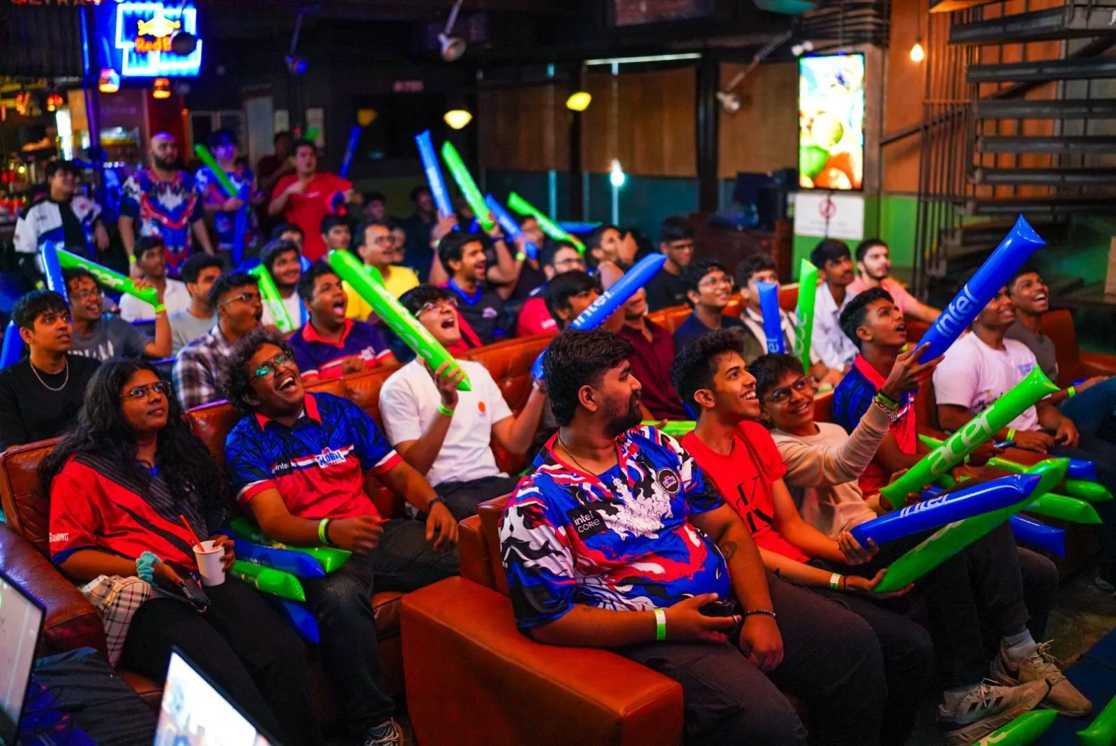Fans in GE jerseys cheering with blue and green thundersticks