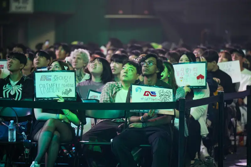 Fans in the Busan crowd holding GE signs